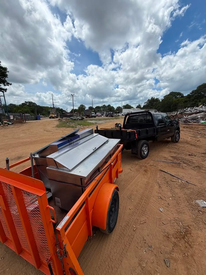 Trailer and truck loaded with commercial equipment for junk removal in Gwinnett County