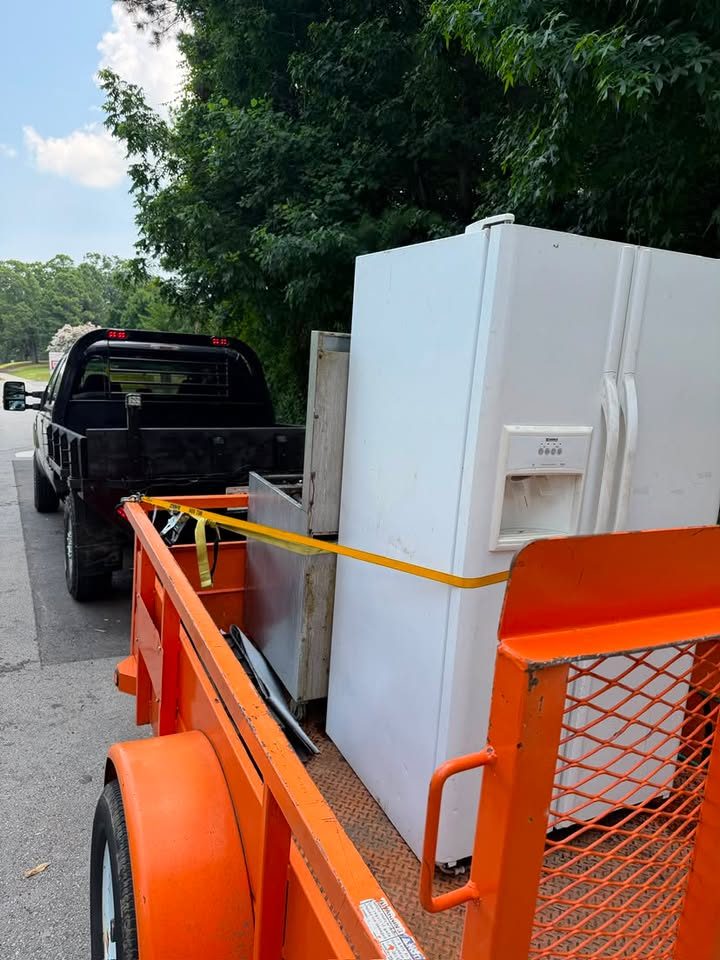 Old refrigerator and cabinet hauled away on trailer in Buford GA