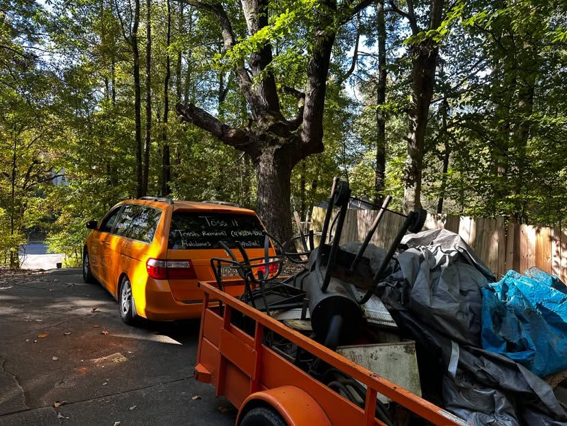 Toss It Trash Removal van and trailer hauling furniture and junk in North Georgia